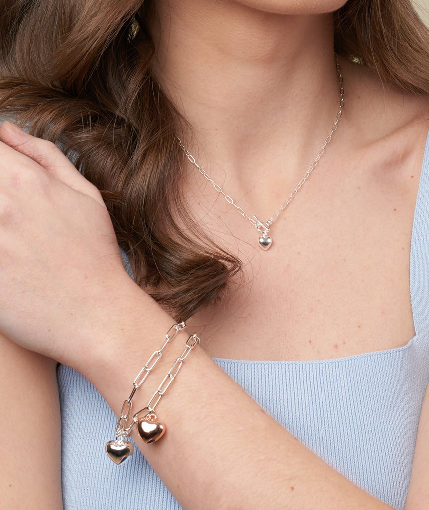 model displaying silver necklace with fob and silver heart